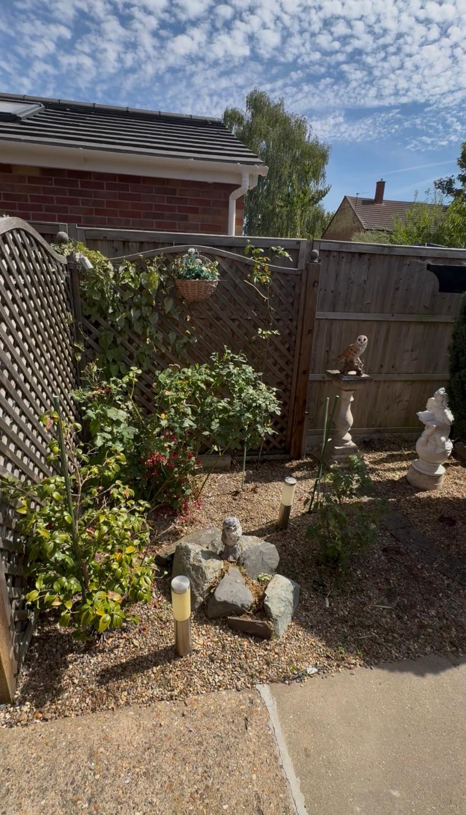 Ornamental gravel garden with rockery, solar lights and garden ornaments maintained by ELawnCare in Cambridge